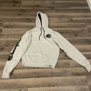 Champion grey hoodie size small with green and black camo writing on arm